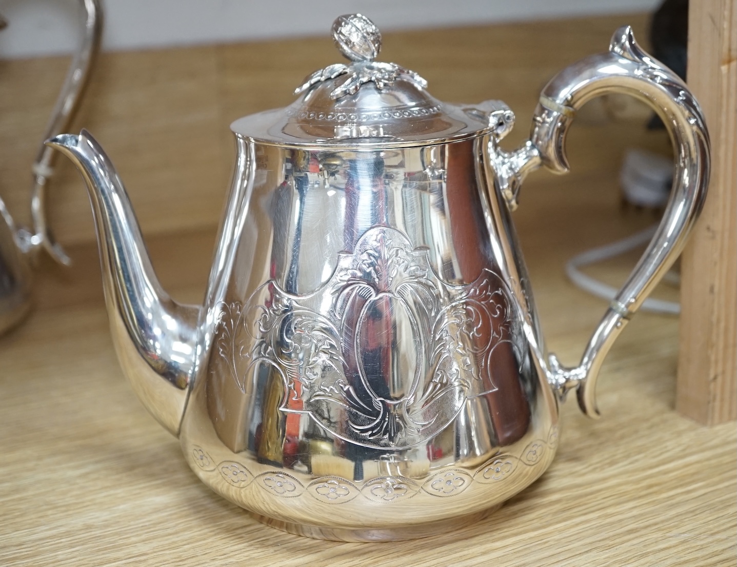 An Art Deco three piece silver brush set and a silver plated three piece tea set and miniature caldron, coffee pot 22cm high. Condition - fair